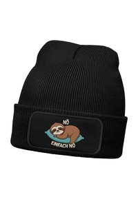Black knitted beanie with a patch featuring a cartoon sloth resting on a blue pillow, with the text "NÖ EINFACHA NÖ" above.
