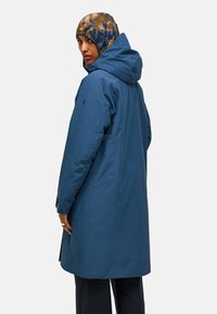 Blauwe waterdichte jas met een capuchon, met een strak ontwerp, lange silhouet en subtiele branding op de mouw. Geweven patroon hoed.
