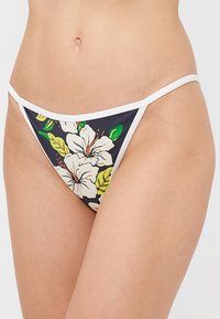 Floral bikini bottom featuring a navy background, white trim, and vibrant hibiscus and leaf patterns, constructed from stretch fabric.