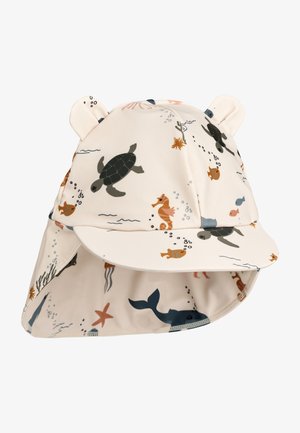 Bērnu saules cepure gaiši bēšā audumā ar jūras radību rakstu, tostarp bruņurupučiem, zivīm un jūras zirgiem. Ar lāču ausiņām un plašu maliņu.