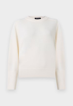 Maglione a maniche lunghe color crema con polsini e orlo a costine, scollatura a girocollo e una etichetta nera sul colletto posteriore.