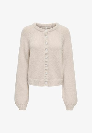 Krēmkrāsas adīta jaka ar apaļu kakla izgriezumu, gariem piedurknēm, ribotiem aprocēm un apakšmalu, kā arī aizmugurē ar septiņām baltām pogām aiztaisāma.