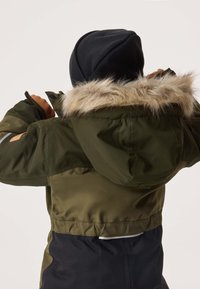 Green parka jacket with a faux fur-lined hood, elastic waist, and black lower section. Features a smooth texture and reflective accents.