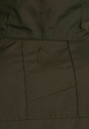 Dark olive green fabric with a smooth texture, featuring stitching details and a small triangular embroidered accent on the surface.