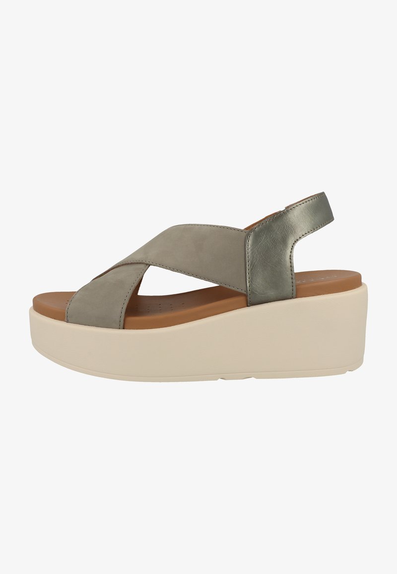 Grå lädersandal med korsade remmar, mjukt innertyg och en ljus färg på kilklacken. Har en slät yta och minimala detaljer.