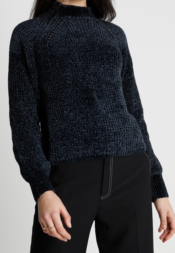 Dark blue ribbed knit sweater with a high neckline and textured finish, featuring long sleeves and a relaxed fit.