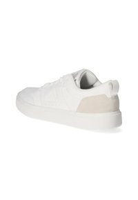 White athletic shoe with a textured white and beige suede heel, flat laces, and a cushioned sole, featuring embossed branding on the side.