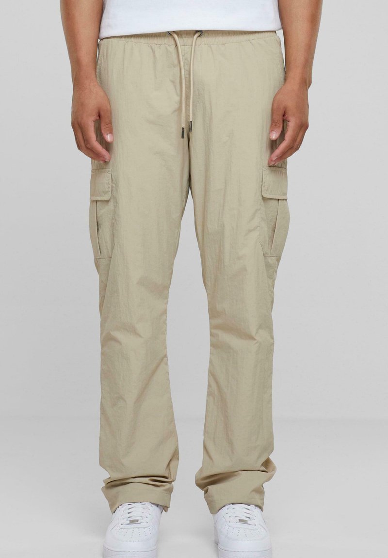Beige cargo pants met een elastische tailleband, trekkoord en meerdere zijzakken. Gemaakt van lichtgewicht stof met een relaxte pasvorm.