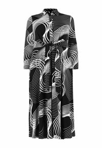 Abito a bottoni bianco e nero con maniche lunghe, caratterizzato da un motivo a linee ondulate e dettaglio in vita con fiocco. Tessuto liscio, lunghezza al ginocchio.