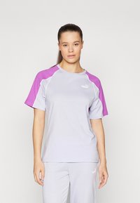 Ljuslila tränings-t-shirt med korta, lila ärmar. Har rund hals och en liten vit Puma-logga framtill. Slät tygkänsla.