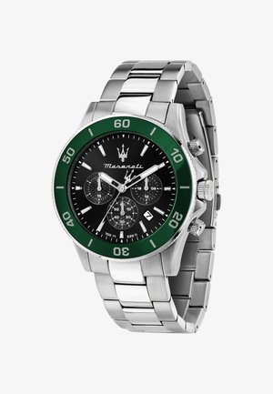 Stainless steel watch with a black dial, green bezel, three sub-dials, and silver accents. Features a linked bracelet and date display.