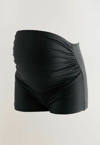 Mustad kortsud triiksärgid rasedatele, valmistatud elastse kangaga, mis omavad kõrget vöökohta ning siledat tekstuuri mugavuse ja toe tagamiseks.