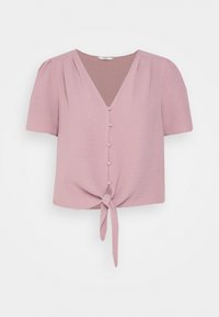 Blusa rosa a maniche corte con scollatura a V, chiusura frontale a bottoni e dettaglio con nodo annodato all'orlo. Tessuto morbido e testurizzato con spalle plissettate.