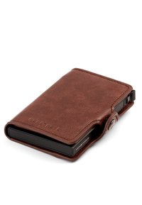 Compact brown leather wallet with a black card holder insert and a button snap closure, branded with "MONEYHOLD" embossing.