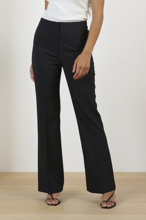 Black tailored trousers with a straight leg design, featuring a smooth fabric texture and a clean waistband, paired with black strappy sandals.