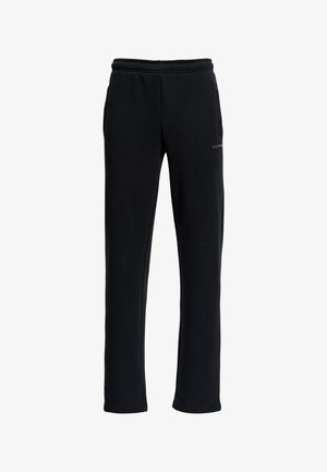 Mustat verkkarit, joissa on normaali istuvuus, joustava vyötärö, sivutaskut ja huomaamaton brändäys helman lähellä. Pehmeä, sileä kankaan tekstuuri.