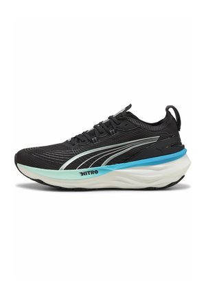 Black athletic shoe with a textured mesh upper, white and light blue accents, cushioned sole, and a prominent “NITRO” logo on the side.