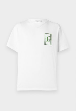 Maglietta bianca in cotone con maniche corte, con un logo verde ricamato in un design rettangolare sull'area del petto sinistro.