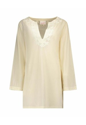 Blouse crème à manches longues avec broderie en dentelle florale autour de l'encolure en V et des manches, réalisée en tissu léger.