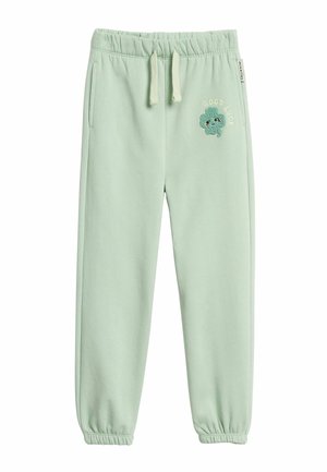 Lichtgroene kindervesten met elastische taille en boorden, trekkoord, zijzakken en een glimlachende klavervlek met de tekst "Good Luck".