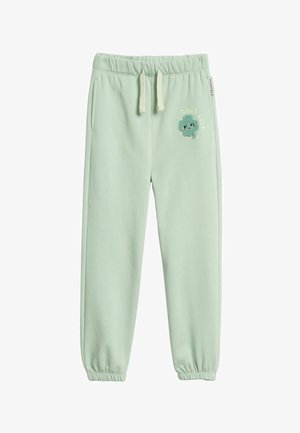 Lichtgroene kindervesten met elastische taille en boorden, trekkoord, zijzakken en een glimlachende klavervlek met de tekst "Good Luck".