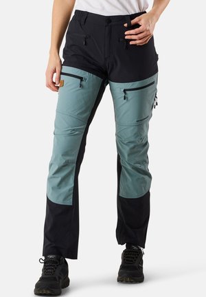 Two-tone hiking pants with a black upper section and teal lower section. Features zippers on pockets and reinforced stitching for durability.