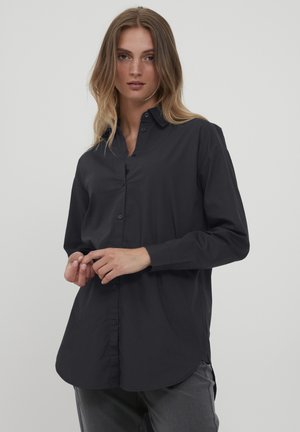 Black button-up shirt with a classic collar, long sleeves, a curved hem, and a smooth texture. Features front buttons and a relaxed fit.
