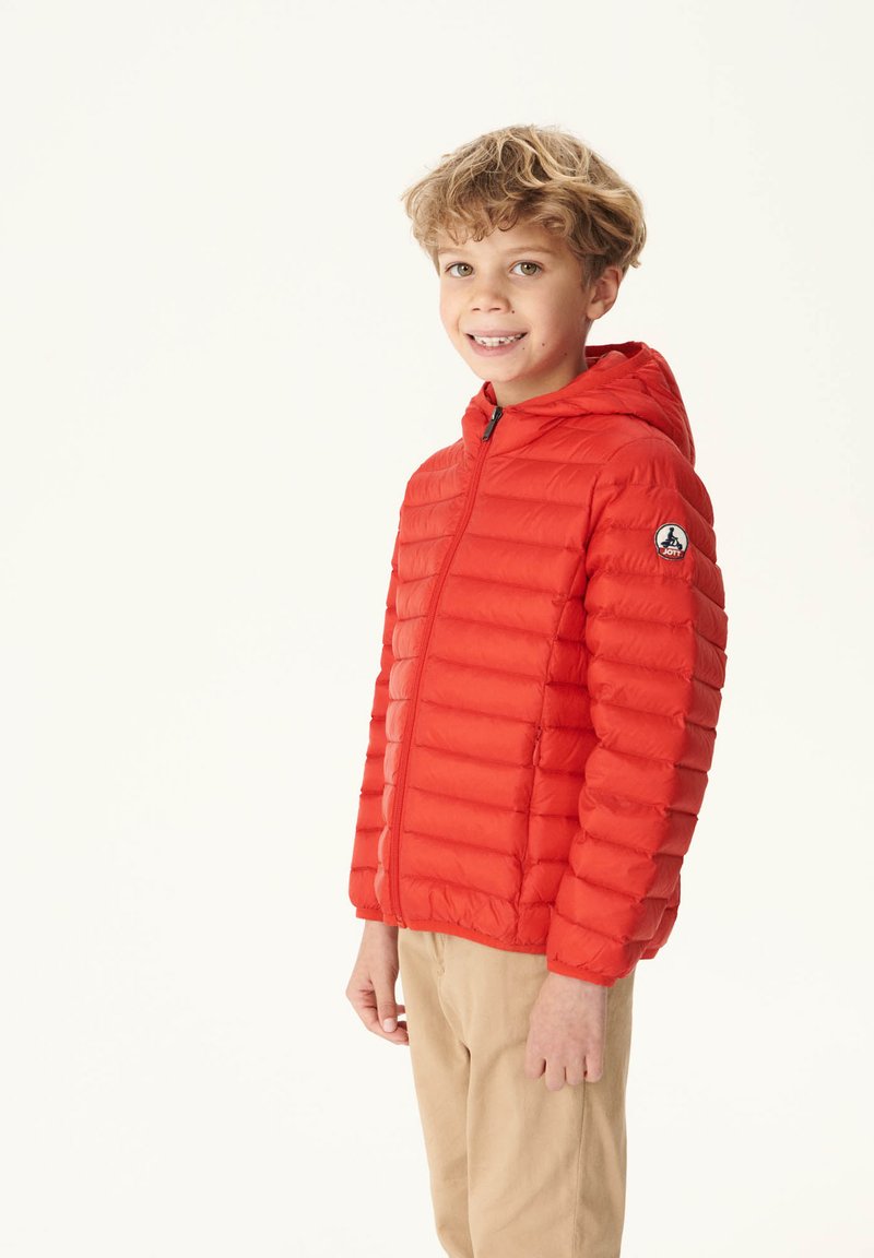 Doudoune rouge avec capuche, présentant des coutures plates et des piqûres horizontales. Comprend un patch logo sur la manche gauche.