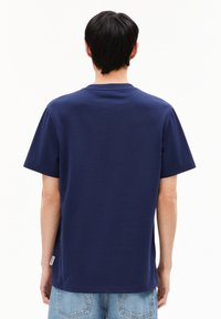 Marineblauw katoenen t-shirt met korte mouwen en een ronde hals. Heeft een label aan de zijkant en een gladde, egale textuur. Geen zichtbare patronen.