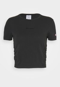 Czarny krótki t-shirt wykonany z miękkiej bawełny, z okrągłym dekoltem, ozdobiony marszczeniem po bokach i małym czarnym logo na piersi.