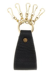Portachiavi in pelle nera con finitura testurizzata, dotato di anello in ottone e cinque clip color oro per tenere chiavi o accessori.