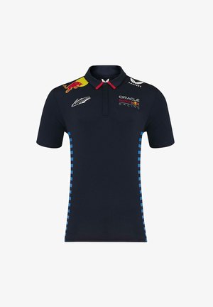 Granatowa koszulka polo z czerwonym kołnierzykiem, niebieskimi wzorzystymi paskami po bokach oraz różnymi logo sponsorów, w tym Oracle i Red Bull Racing.