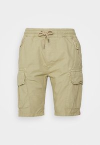Cargo shorts vaale khaki mein, jo drawstring waistband, do side zip pockets, aur side cargo pockets se saji hui hain. Yeh halki kapde se bani hain.