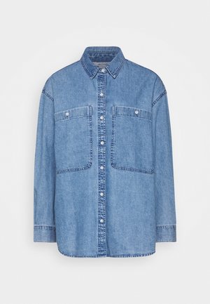 Light blue denim button-up shirt with long sleeves, two front chest pockets with buttons, and a classic collar.