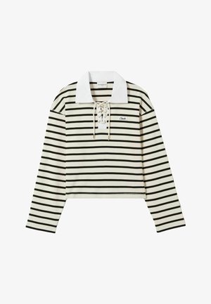 Haut rayé à manches longues en crème et noir, avec un col blanc et un devant à lacets. Il présente un design court et un petit logo sur la poitrine gauche.