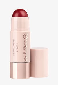 Stick de blush rétractable dans un emballage rose pâle, avec une pointe ronde et scintillante de couleur rouge foncé. Orné du logo de la marque et du nom du produit.