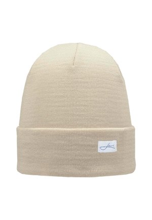 Knit beige beanie with a folded cuff and a small brand label on the front; textured fabric offers warmth and comfort.