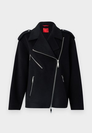 Veste noire en mélange de laine, fermeture éclair asymétrique, trois poches zippées, épaulettes et tissu texturé.