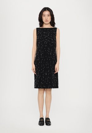Musta hihaton mekko, jossa on valkoista brodeerausta, muodikkaalla ja tiukalla siluetilla sekä polvipituudella. Sujuva pinta, minimalistinen kuosi.