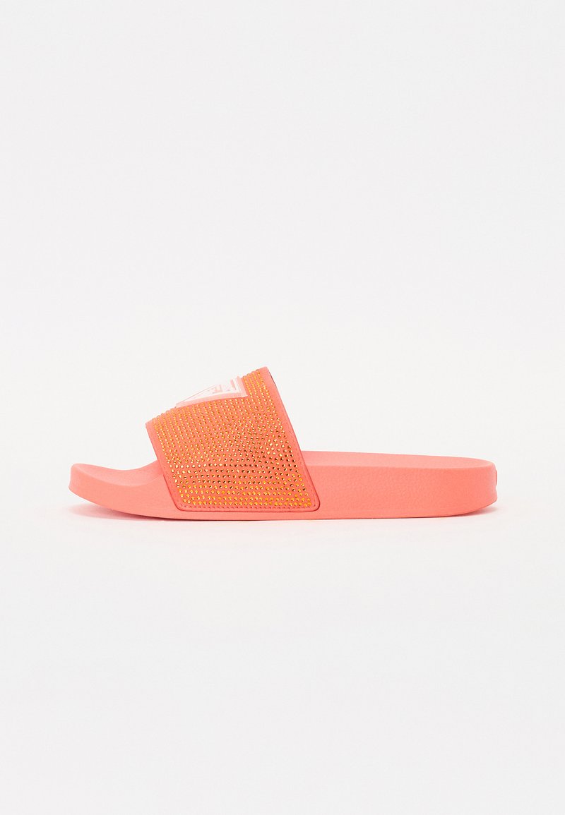 Pink slide sandal with a textured strap featuring gold studs. The footbed is flat, and the overall design is minimalist and casual.