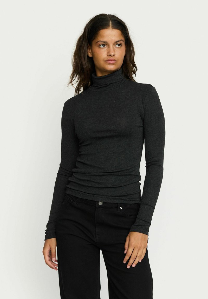 Dark gray turtleneck top with long sleeves, made from a soft, fitted material. Smooth texture and subtle gathering at the waist.