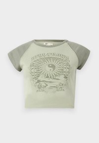 Green cotton t-shirt with short sleeves, featuring a yin-yang graphic and nature motifs in a contrasting darker green tone.