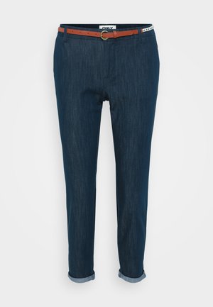 Navy blue denim trousers with rolled cuffs, featuring a brown belt with a gold buckle, and a label reading "ONLY" at the waistband.