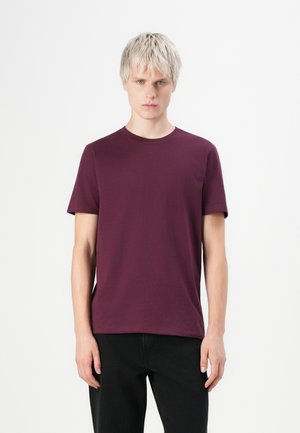 Camiseta de manga corta burdeos hecha de suave tejido de algodón, con un clásico escote redondo y un corte relajado.