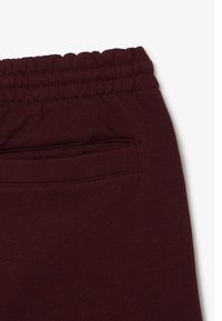Bordeaux joggerbroeken met een elastische tailleband, een soepele textuur en een achterzak met een gestikte rand.