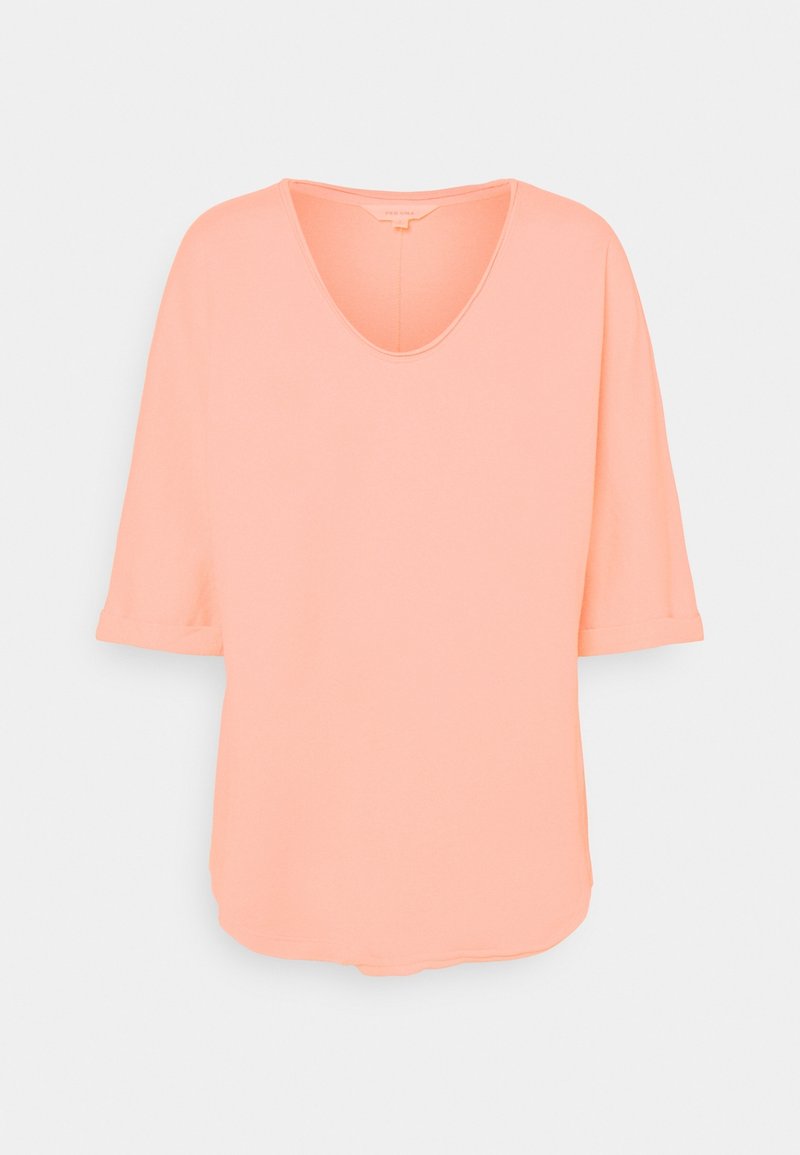 Pfirsichfarbenes T-Shirt aus weichem Stoff, mit tiefem V-Ausschnitt und kurzen Ärmeln mit umgeschlagenen Bündchen. Abgerundeter Saum mit dezenter Naht.