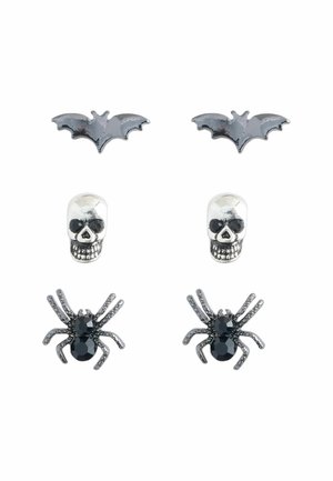 Four pairs of earrings featuring a black bat, silver skull, and black spider designs. Materials include metal and gemstones with intricate details.