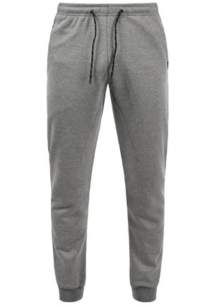 Gray sweatpants made of soft fabric, featuring an elastic waistband with a black drawstring, tapered leg, and side pockets.