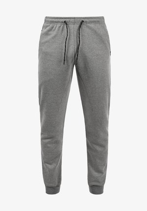 Grå sweatpants lavet af blødt stof, med en elastisk talje med en sort snor, tapered ben og sidelommer.