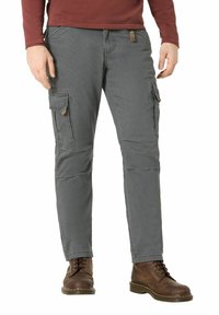 Cargo pants in grey fabric with a smooth texture, featuring two large side pockets and small brown accents. Worn with brown lace-up boots.